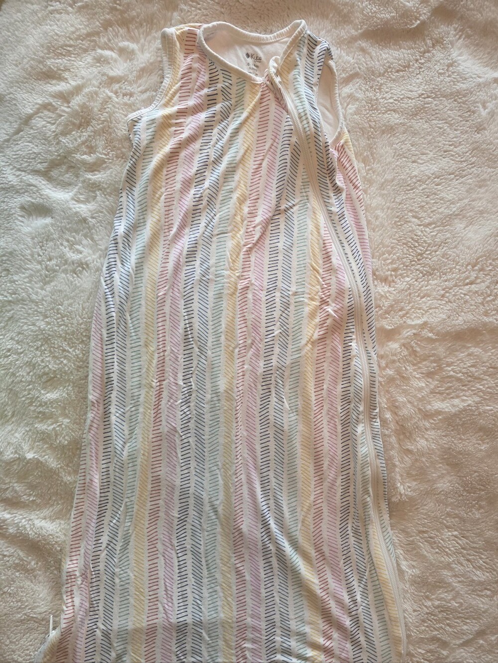 Super soft Kyte Baby sleep sack in a colorful rainbow dash print! Lightweight, s